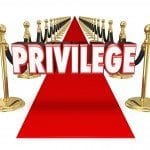 red carpet with word privilege written above it